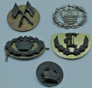 Badge - 1 Signal Corps (blackened) .2 Gun Layer (blackened) .3 Warrant Officer (silver Queens Crown) .4 Warrant Officer (Crown in a wreath) .5 Kings Crown (blackened)