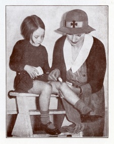 A Melbourne District Nursing Society (MDNS) Sister dressing a child's wound