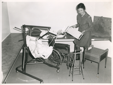 A Royal District Nursing Service (RDNS) Sister viewing RDNS equipment which can be loaned to patients