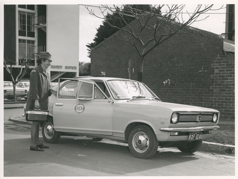 A Royal District Nursing Service (RDNS) Sister about to enter a RDNS vehicle
