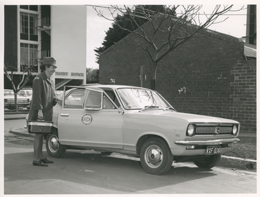 A Royal District Nursing Service (RDNS) Sister about to enter a RDNS vehicle