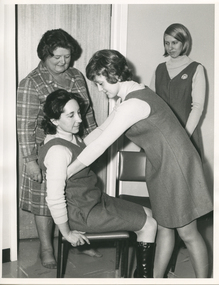 A Physiotherapist instructing Royal District Nursing Service (RDNS) Sisters how to transfer from a chair