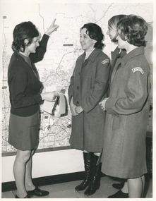 A Royal District Nursing Service (RDNS) Educator showing RDNS Sisters the area map in RDNS Heidelberg Centre