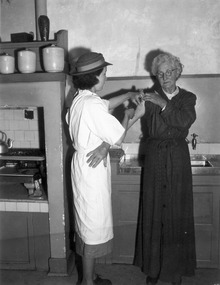 Melbourne District Nursing Society (MDNS) Sister administering an injection