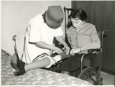 Royal District Nursing Service (RDNS) Sister visiting a lady and applying her leg brace