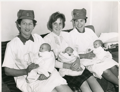 Two Royal District Nursing Service (RDNS) Post Natal Service Sisters visiting a mother and her triplets