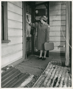 A Royal District Nursing Service (RDNS) Sister at the door of a patient's home