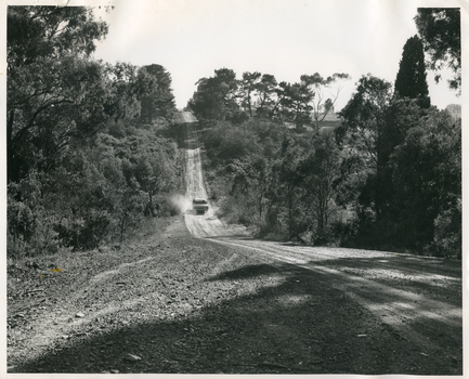 A Royal District Nursing Service (RDNS) Sister travelling on a dirt road
