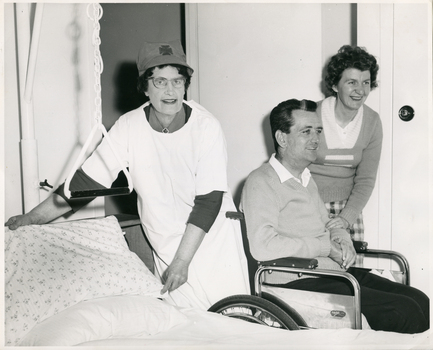 A Melbourne District Nursing Service (MDNS) Sister in the home of a patient