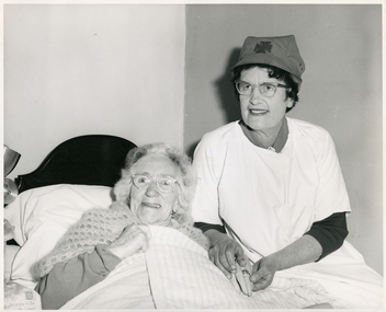 A Melbourne District Nursing Service Sister administering care 