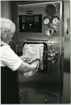 A Royal District Nursing Service (RDNS) Sister emptying an Autoclave