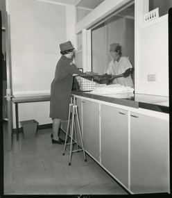 A Melbourne District Nursing Service (MDNS) Sister receiving sterilized equipment at MDNS Footscray Centre