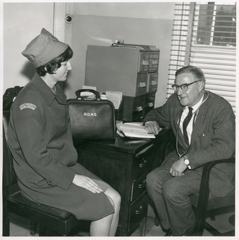 A Royal District Nursing Service (RDNS) Sister visiting a Doctor to discuss a patient's care
