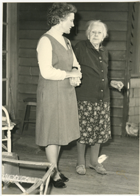 A Royal District Nursing Service (RDNS) Sister taking an elderly lady for a walk