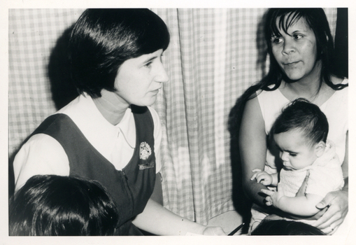 A Royal District Nursing Service (RDNS) Sister visiting a mother and babe in their home