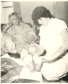 A Royal District Nursing Service (RDNS) Sister attending to a patient's wound care in their home