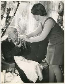 A Royal District Nursing Service (RDNS) Sister visiting a gentleman in his home