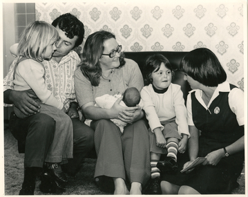 A Royal District Nursing Service (RDNS) Sister visiting a family
