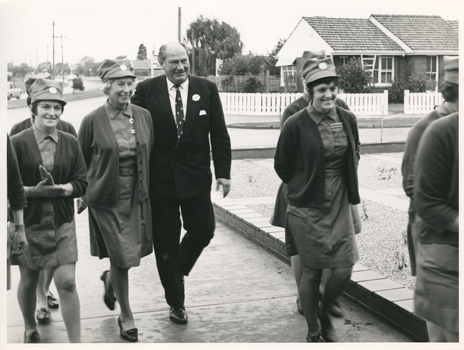 A group of Royal District Nursing Service (RDNS) Sister walking with Mr. John Rossiter Victorian Minister of Health