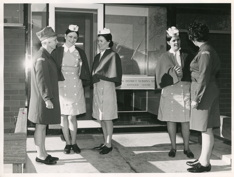 Royal District Nursing Service (RDNS) Sister outside Footscray Centre with Footscray Hospital student nurses