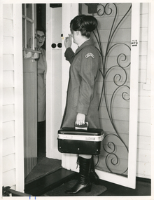 A Royal District Nursing Service (RDNS) Sister about to enter a patient's home