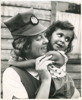 Sister Tarn of Royal District Nursing Service (RDNS) holding a young patient