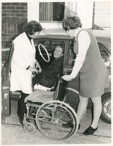 A Royal District Nursing Service (RDNS) Liaison Officer assisting a patient to transfer into a car