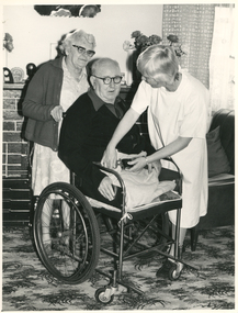 A Royal District Nursing Service (RDNS) Sister attending to a gentleman in his home