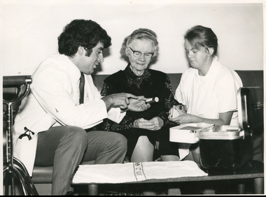 A Medical Student and a Sister from the Royal District Nursing Service (RDNS), visiting and instructing a lady in her home