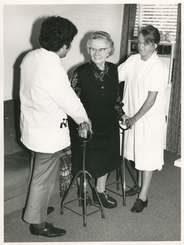 A Medical Student and RDNS Sister assisting a lady to ambulate.