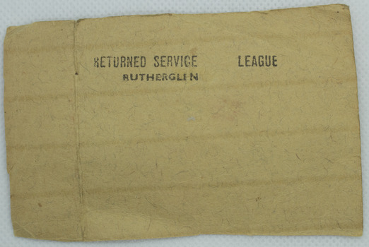 Retangle shaped card with black stamp that reads: " RETURNED SERVICE LEAGUE / RUTHERGLEN".