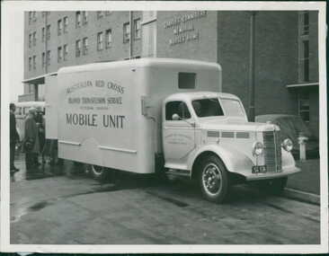 Photograph, Photo of a Australian Red Cross Mobile Unit Bedford K Series van, Circa 1952, providing a blood transfusion service outside of the Charles Connibere Memorial Nurses Home (built 1944, demolished 2005), Royal Melbourne Hospital - Department Of Health - Publicity material