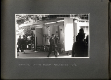 Photograph, A street view of the chest x-ray caravan, with a qeue, operating outside of Centreway Collin St in 1962 - 2 of 3 Photos - Department of Health - Tuberculosis Branch - Publicity material