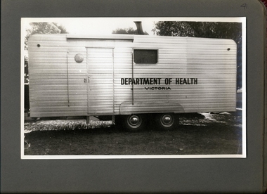 Photograph, Profile of a Department of Health Caravan parked on a lawn under a tree - Department of Health