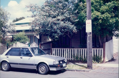 Photograph, 2 x terraced wooden houses on street corner with wattle trees in front yard - City Landscapes - Photo taken by Property Management Services / Public housing - Inner City Melbourne - Early 1980s