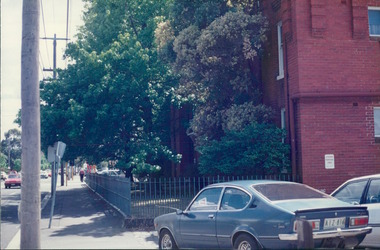 Photograph, View of the back of a 1976 Holden Gemini TX through to the corner & sides of a tenement building - City Landscapes - Photo taken by Property Management Services / Public housing - Inner City Melbourne - Early 1980s
