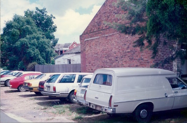 Photograph, A panel van, station wagons & sedans & overgrown fences - Car parking facilities - City Landscapes - Photo taken by Property Management Services / Public housing - Inner City Melbourne - Early 1980s