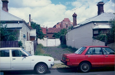 Photograph, A vacant block between wooden terraced houses - City Landscapes - Photo taken by Property Management Services / Public housing - Inner City Melbourne - Early 1980s