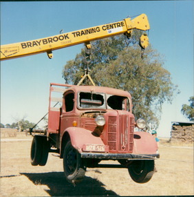 Photograph, A Bedford K Series truck circa 1952, hoisted up by crane supplied by Braybrook Training Centre - Photo taken by either staff or trainee from Langi Kal Kal Youth Training Centre (YTC) circa 1980s to 1993