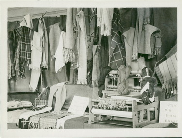 Photograph, A hand operated textile loom surrounded by products, such as scarves, made on the loom by patients, at Gresswell Sanitorium, as a contribution to the war effort - Mont Park - June 1946