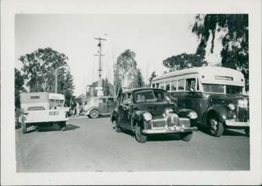 Photograph, To the right of the photo is a 1943/44 Grummet bodied Ford (thanks to identification by the Bus & Coach Society Victoria). Centre of the photo is one of the first Holden sedans, built in 1948 - the street view backdrop is the entrance to Gresswell Sanitorium - Mont Park