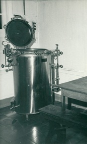 Photograph, Donated autoclave “If this only sterilizer (used only whenever all drums are filled to save electric power) breaks down, the hospital does not have sterile gauze or towels" - Equipment donated through Ziarah the Gull Force Association 2/21 Bn AIF / Dr John Forbes Fairfield Hospital & Caltex - Photo from Dr John Forbes photo albums - Ambon Hospital