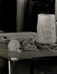Photograph, Examples, in way of a spindle and a ball of thread as material for weaving on a loom at a Caloola Sunbury workshop circa 1960
