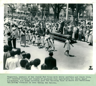 Tinymites, members of the Junior Red Cross marching past the saluting base and the Acting Governor of the British West Indies - Department of Health – National Fitness Office (Sports & Recreation) – Press Release Photo - Empire Youth Day & Royal Tours