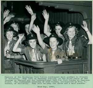 Members of the Rhodesian Girl Guides contingent wave goodbye to friends at Salisbury starting a journey to England to an International Camp at Beaconsfield - 31/05/1952 - Department of Health – National Fitness Office (Sports & Recreation) – Historical Press Release Photo Collection