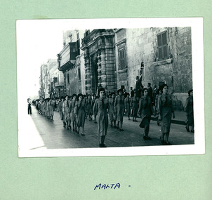 A photo of Girl Guides marching past officials standing on a salute base in Malta - Department of Health – National Fitness Office (Sports & Recreation) – Historical Press Release Photo Collection