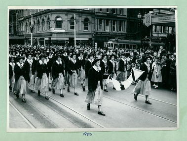 School children, from an unidentified school, march past the Melbourne Town Hall Swanston Street, Melbourne CBD Australia, from the War Memorial in 1954 - Department of Health – National Fitness Office (Sports & Recreation) – Historical Press Release Photo Collection