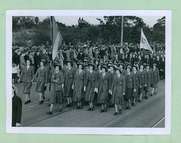 Different College groups marching over Princes Bridge towards Flinders Street Station and the salute base in front of the Melbourne Town Hall on Swanston Street, Melbourne CBD Australia, from the War Memorial - Department of Health – National Fitness Office (Sports & Recreation) – Historical Press Release Photo Collection