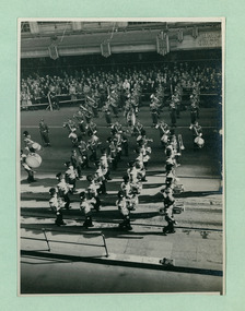 Two Brass Bands, one marching, one stationary, in front of the salute base in front of the Melbourne Town Hall on Swanston Street, Melbourne CBD Australia, from the War Memorial - Department of Health – National Fitness Office (Sports & Recreation) – Historical Press Release Photo Collection