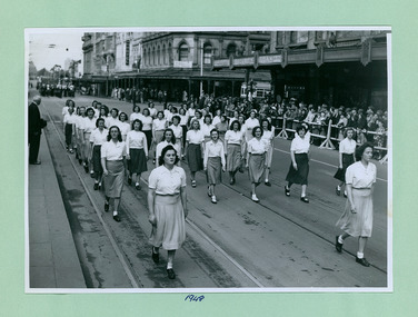 An unidentified group of women marching past the salute base in front of the Melbourne Town Hall on Swanston Street, Melbourne CBD Australia - 1948, from the War Memorial - Department of Health – National Fitness Office (Sports & Recreation) – Historical Press Release Photo Collection